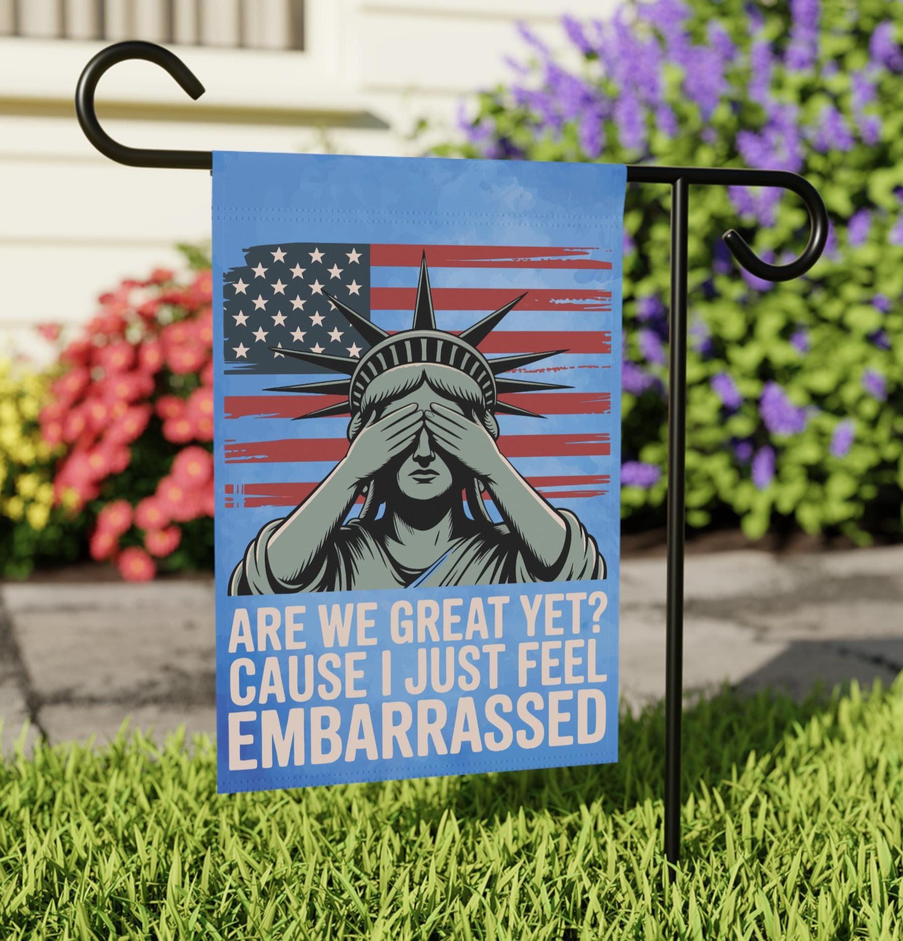 Blue lady liberty outdoor garden flag. Accented with an American flag and a slogan that states "Are we great yet? Cause I just feel embarrassed".
