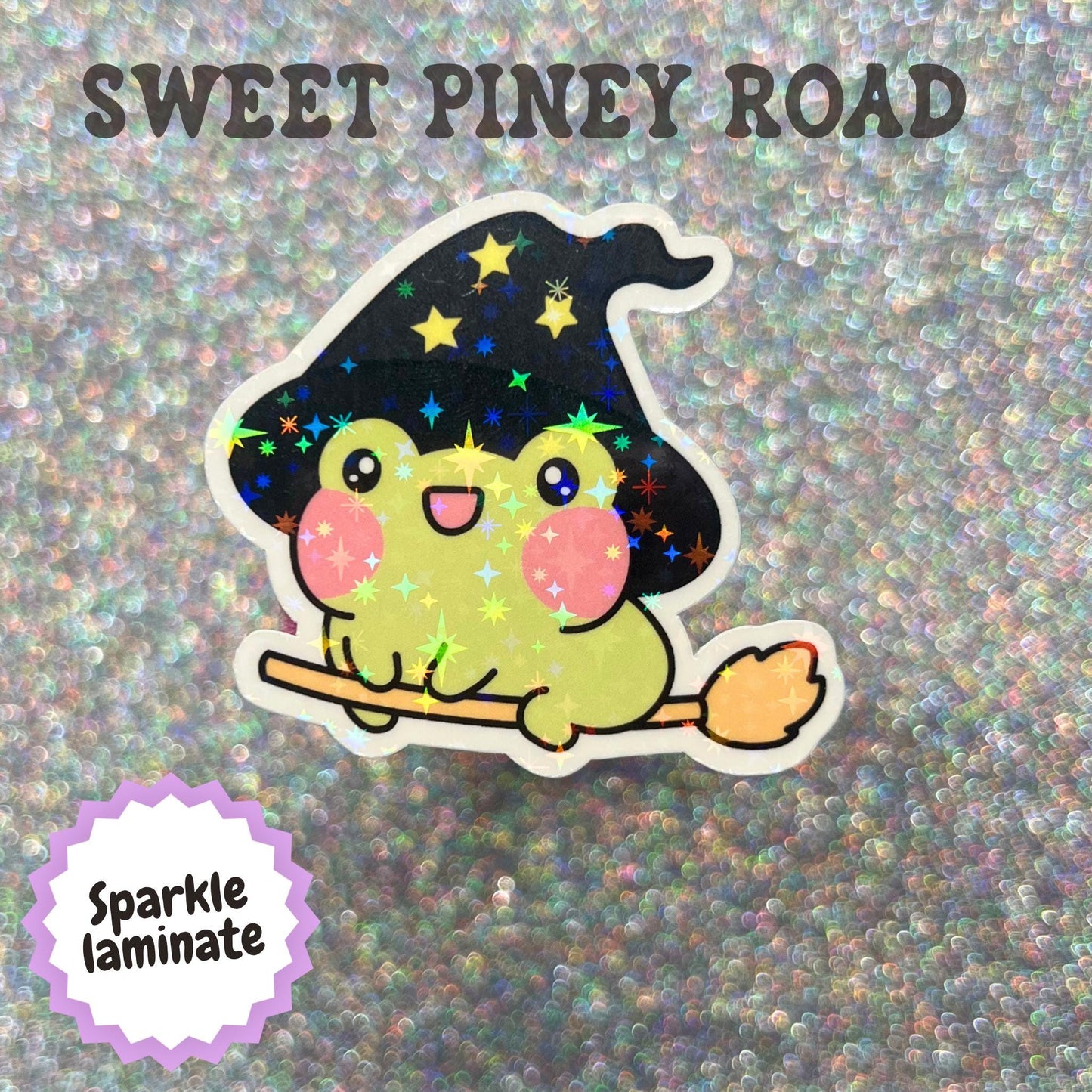 Cute kawaii green toad wearing a black witch hat and riding a broomstick, featuring a whimsical Halloween design and magical cottagecore aesthetic.