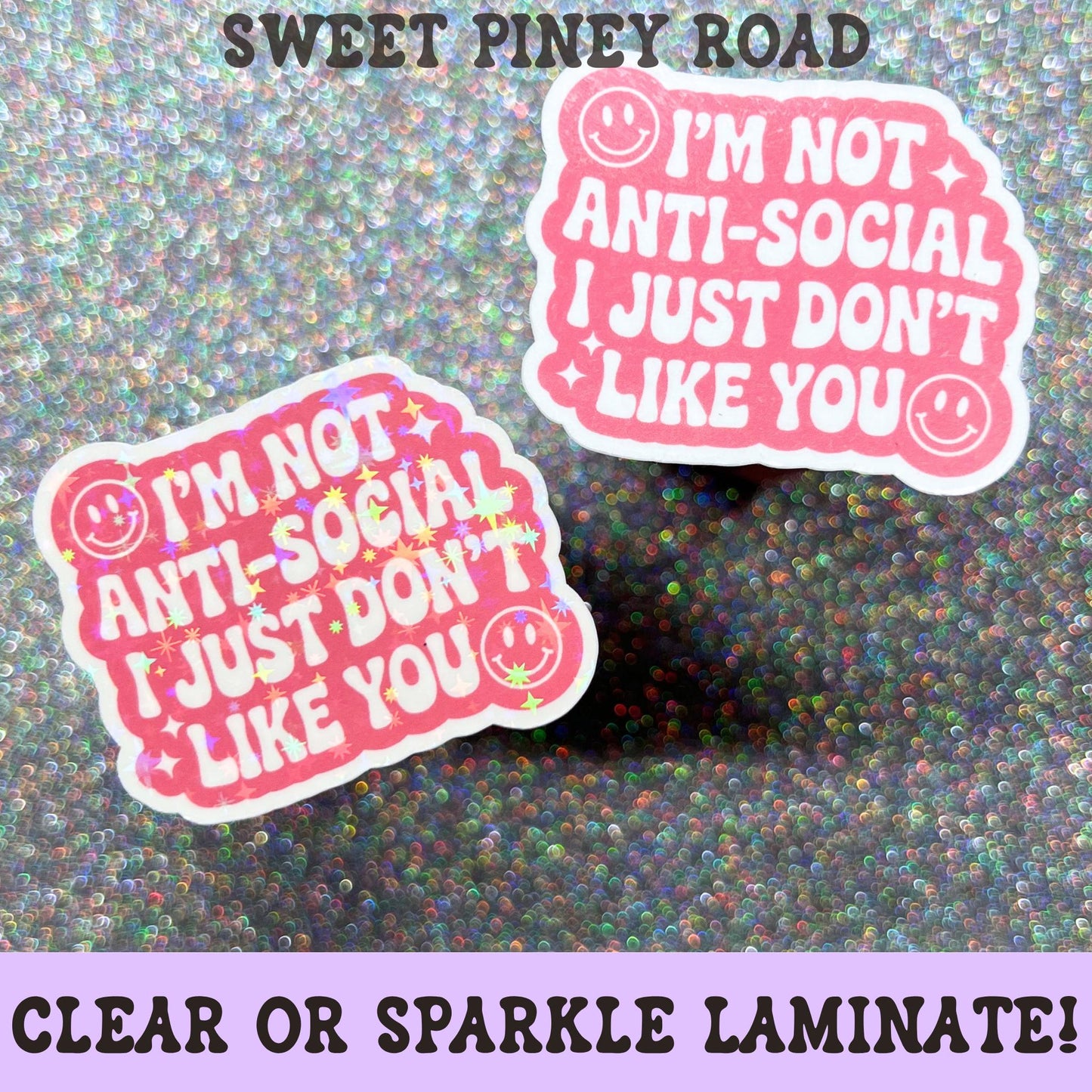 Pink and white sarcastic sticker featuring the phrase I'm Not Anti Social I Just Don't Like You with smiling face accents on a clear laminate finish.
