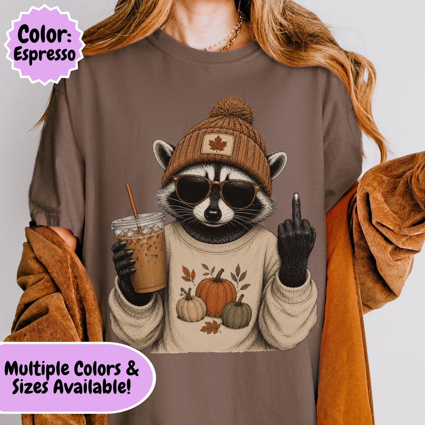 Funny raccoon wearing a knit beanie, sunglasses, and a cozy sweater with pumpkins while holding an iced coffee and making a rude hand gesture, humorous autumn graphic with fall leaves and seasonal vibes.