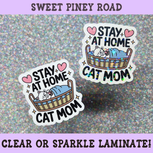 Cute stay at home cat mom sticker featuring a sleeping cat in a cozy bed with sparkly accents, perfect for cat lovers and introverts.