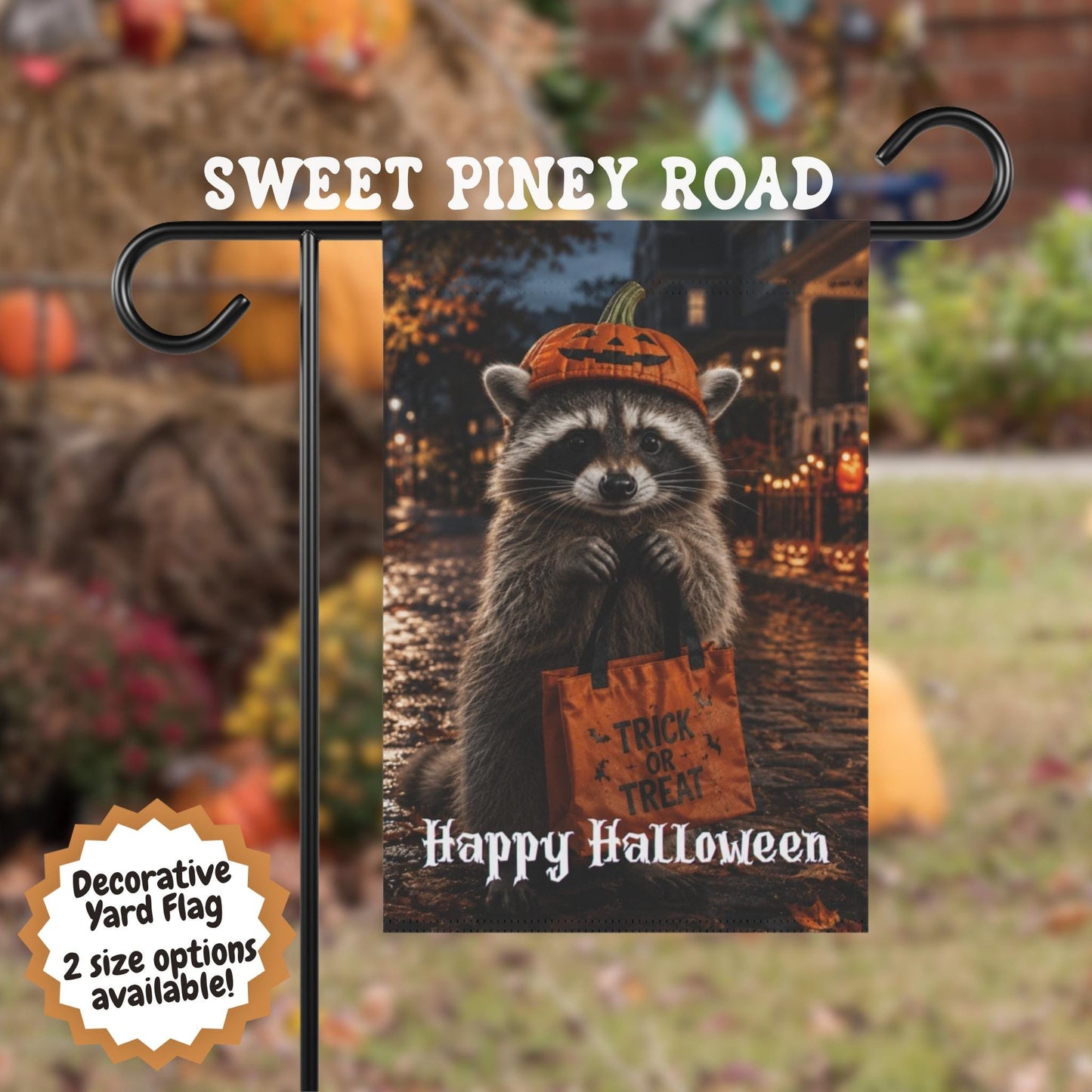 Halloween raccoon yard flag featuring a cute raccoon wearing a pumpkin hat and holding a trick or treat bag on a festive autumn street with glowing jack-o'-lanterns and fall decorations.