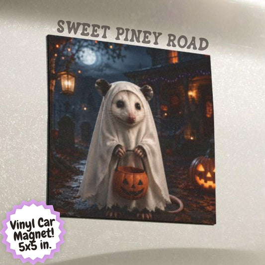 Cute possum wearing a ghost costume and holding a pumpkin trick or treat bucket in a moonlit Halloween scene with pumpkins, autumn leaves, and a spooky decorated house.