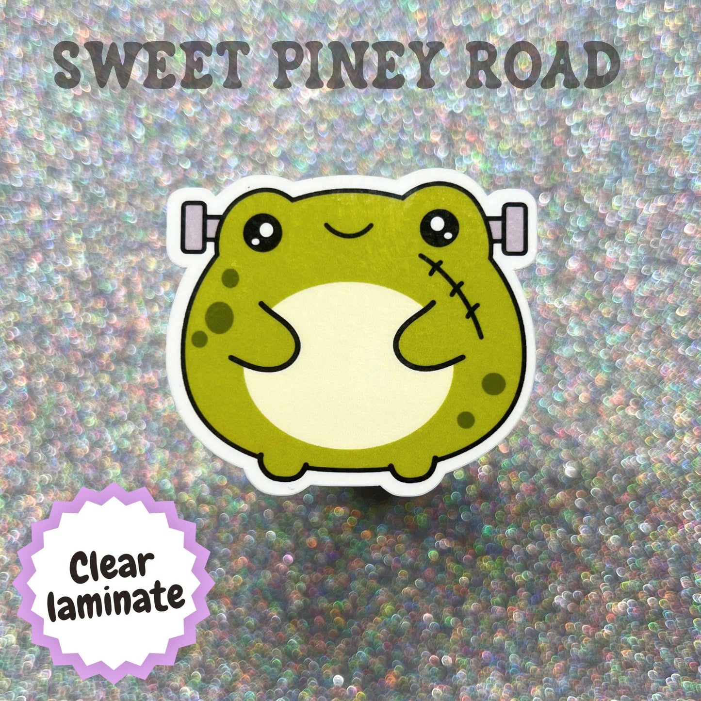 Cute kawaii Frankenstein toad sticker featuring a green frog with stitched details and metal bolts, illustrated in a playful Halloween style.