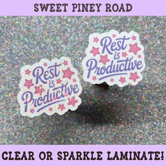 Pastel motivational sticker reading "Rest Is Productive" with pink stars and purple lettering, self-care themed decal.