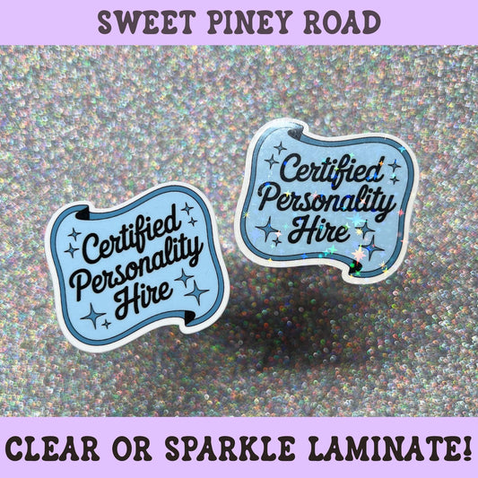 Funny office sticker reading "Certified Personality Hire" in blue lettering with decorative stars, workplace humor decal.