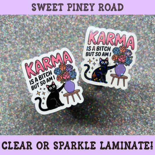Funny black cat sticker featuring the phrase "Karma Is A Bitch But So Am I" with a black cat beside a vase of colorful flowers.