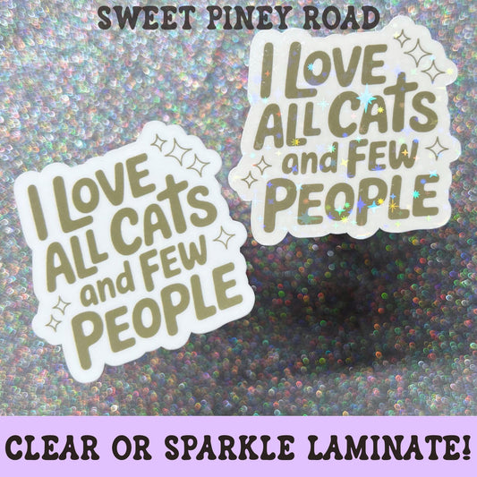 Funny cat lover sticker featuring the phrase I Love All Cats And Few People in olive green lettering with decorative sparkles.