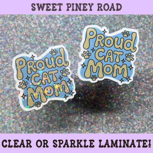 Cute Proud Cat Mom sticker with paw prints and sparkly accents in blue and cream colors, perfect for cat moms and cat lovers.