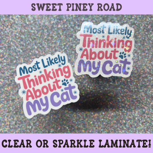 Cute cat lover sticker reading "Most Likely Thinking About My Cat" with colorful lettering, paw print accents, and holographic sparkle laminate.